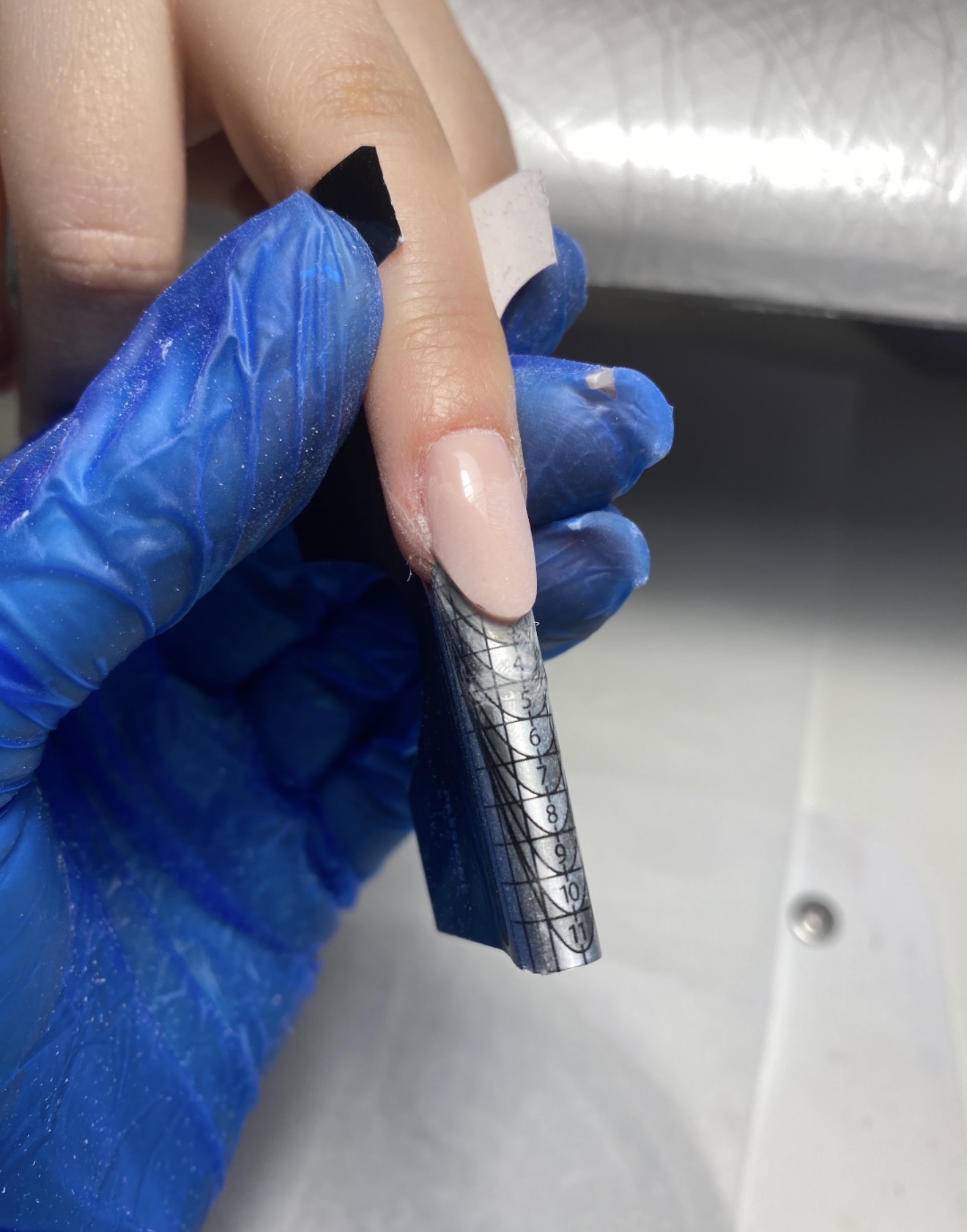 Nail extension sculpting with a form during professional nail training