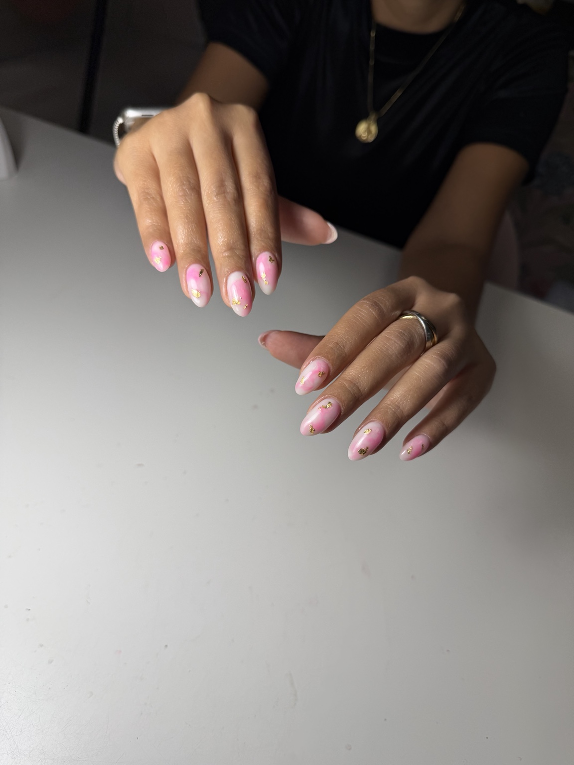 Pink manicure with gold accents showing professional salon nail skills