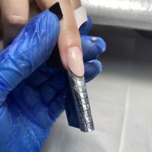 Gel nail extension using a sculpting form during Focus Gel Level 2 training in London